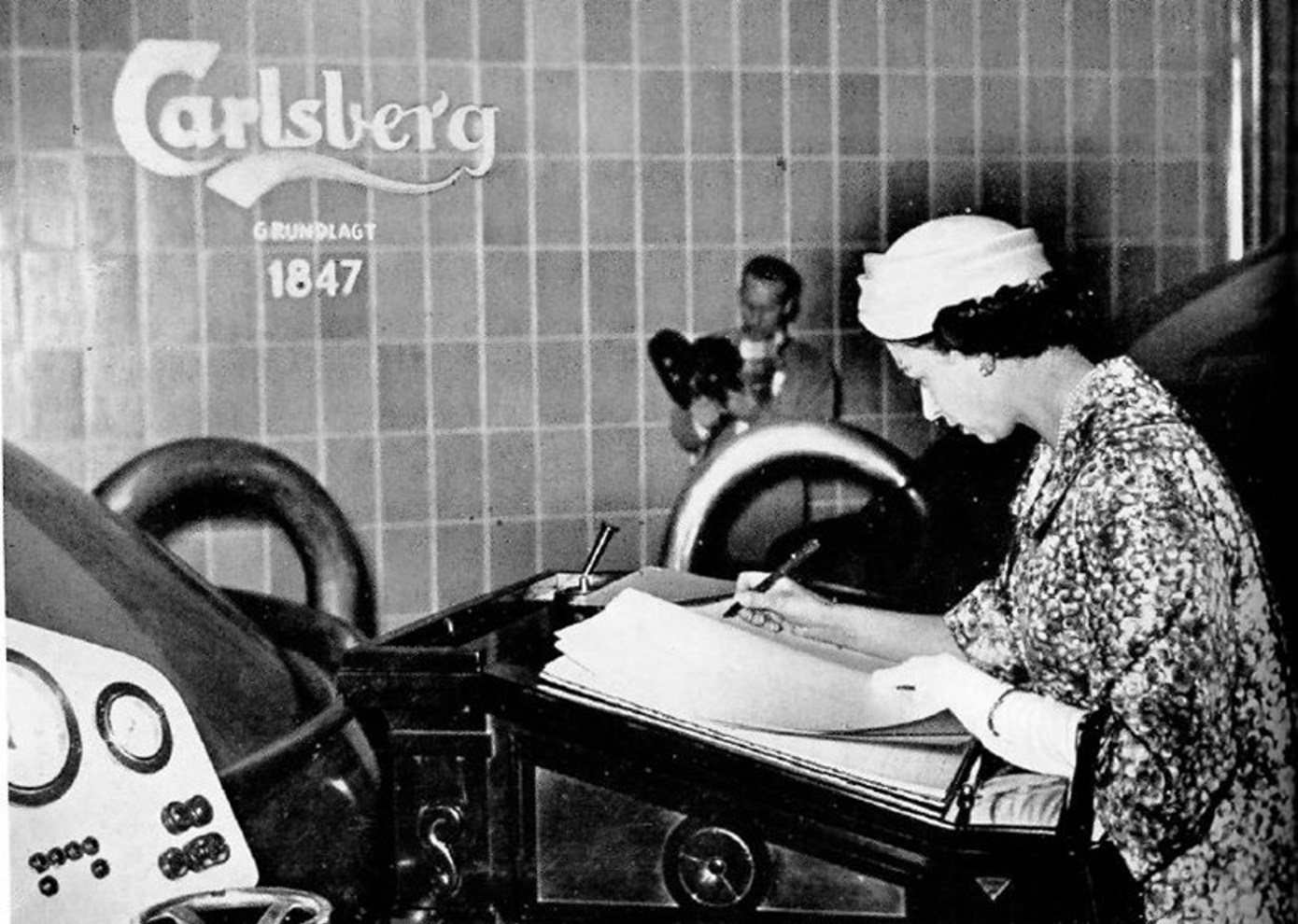 HM Queen Elizabeth II signing the Carlsberg guest book